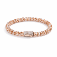 Luxurious 18KT rose gold bracelet showcasing woven diamond-studded links with a secure diamond clasp on a white background.