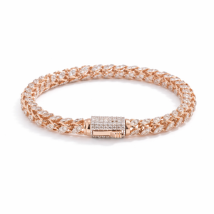 Luxurious 18KT rose gold bracelet showcasing woven diamond-studded links with a secure diamond clasp on a white background.