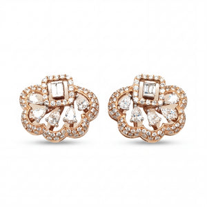 Elegant 18KT rose gold stud earrings featuring floral openwork design with baguette and pear-shaped diamonds on a white background.
