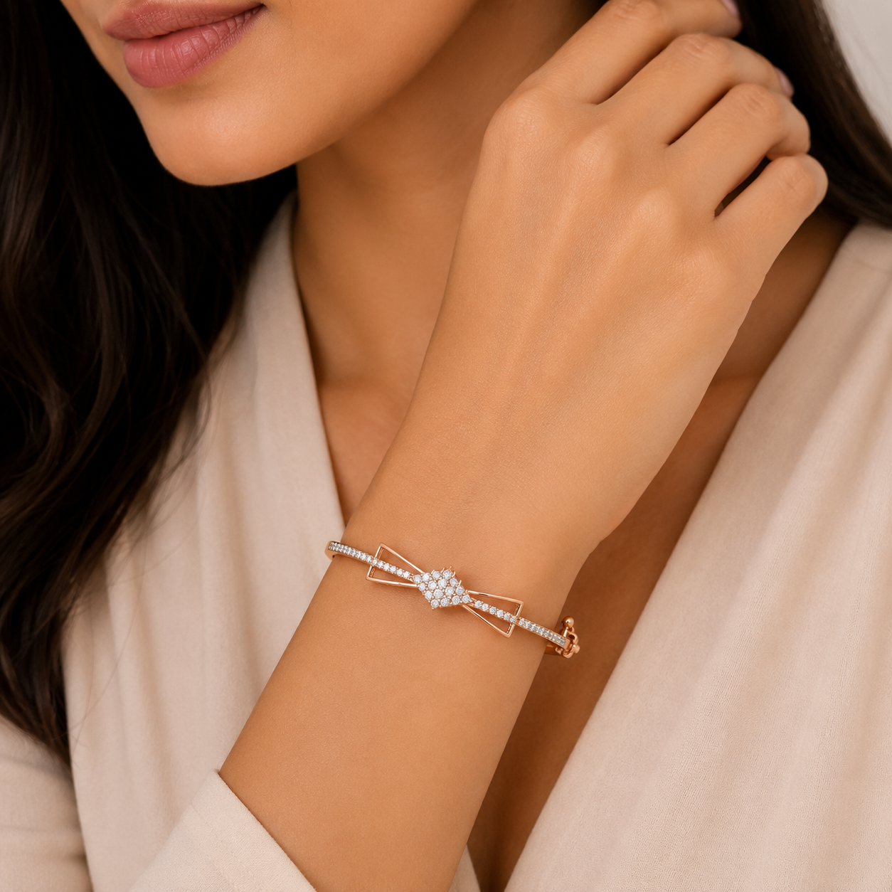 Elegant 18KT rose gold kada bracelet featuring a delicate bow-inspired design with a sparkling pavé diamond center and diamond-studded band, beautifully worn on a woman's wrist, perfect for everyday elegance, gifting, and special occasions.