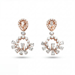 Elegant 18KT rose gold chandelier earrings featuring pear-shaped diamond tops with floral drop clusters on a white background.