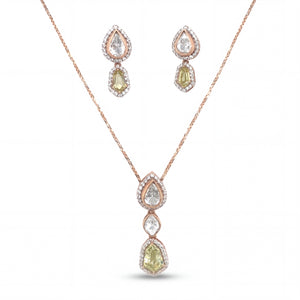 Elegant 18KT rose gold pendant set featuring pear and cushion-cut gemstone drops with diamond halo detailing and matching earrings on a white background.