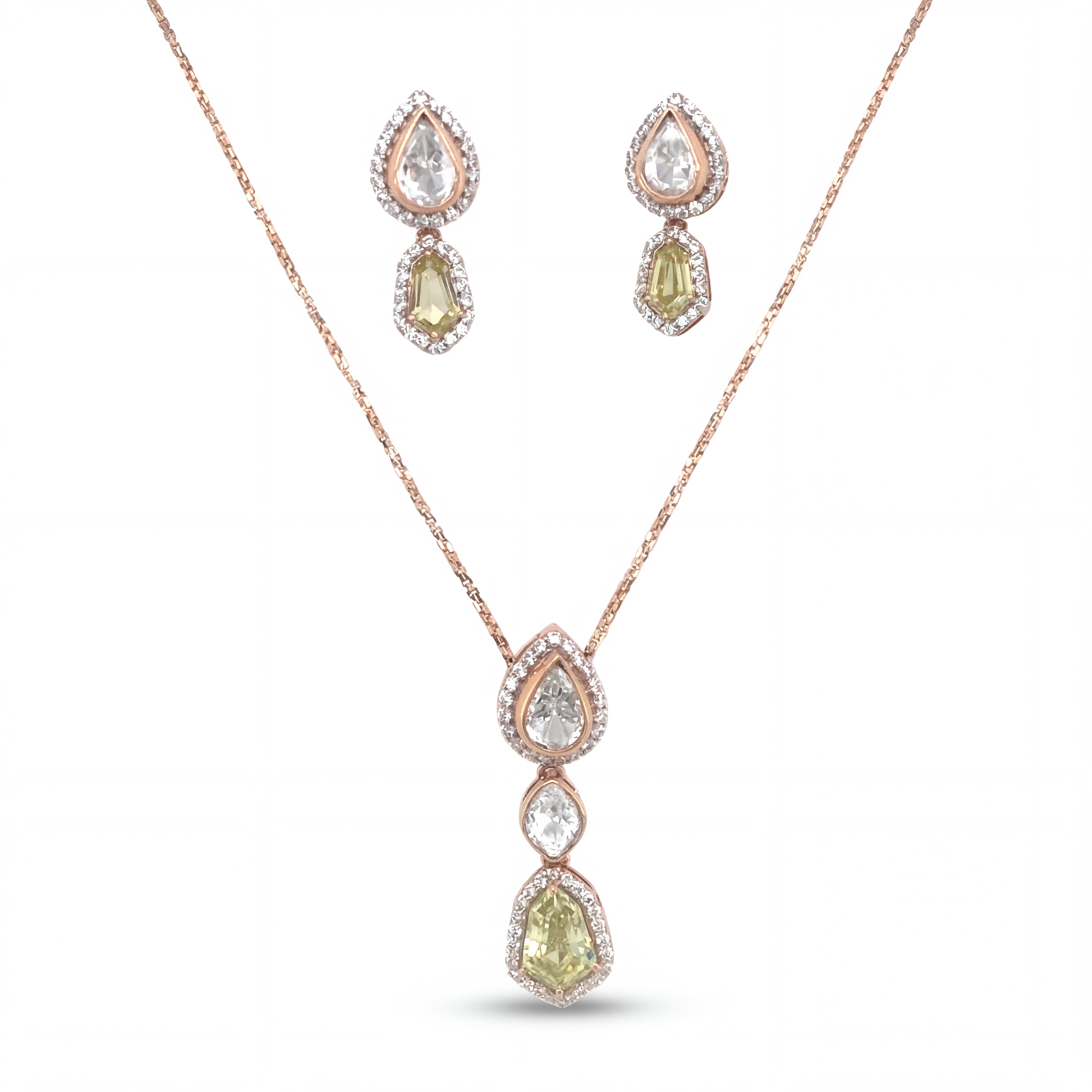 Elegant 18KT rose gold pendant set featuring pear and cushion-cut gemstone drops with diamond halo detailing and matching earrings on a white background.