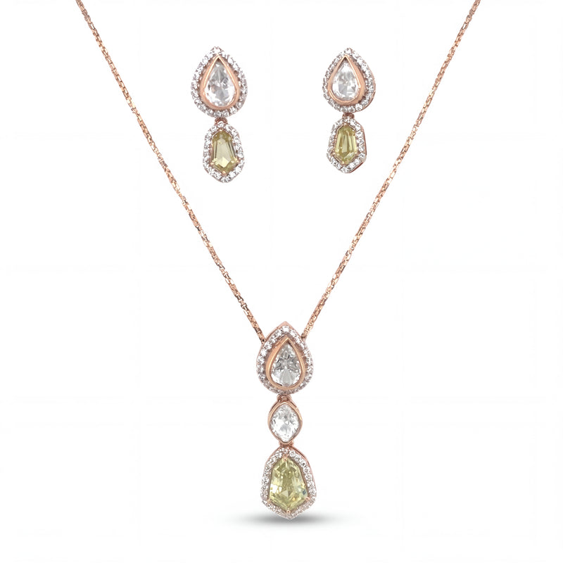 Elegant 18KT rose gold pendant set featuring pear and cushion-cut gemstone drops with diamond halo detailing and matching earrings on a white background.