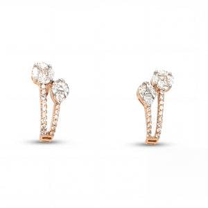 Elegant 18KT rose gold huggie earrings featuring dual diamond tops with pavé-set curved hoops on a white background.