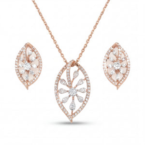 Elegant 18KT rose gold pendant set featuring leaf-shaped diamond pendant with matching floral earrings on a white background.
