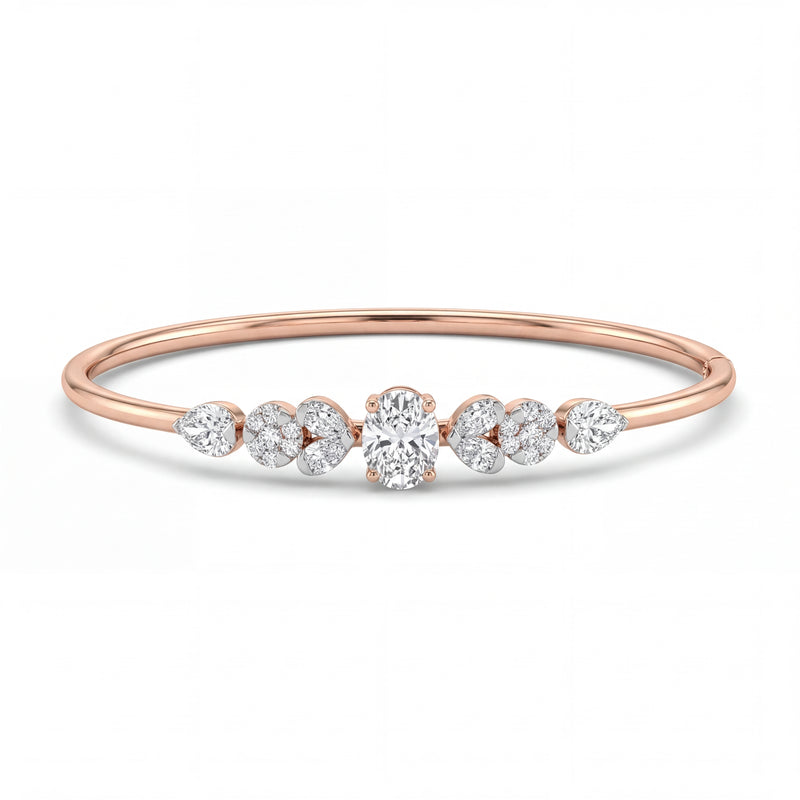 Elegant 18KT rose gold bangle featuring a central round solitaire diamond with pear-shaped side diamonds in a sleek minimalist design on a white background.