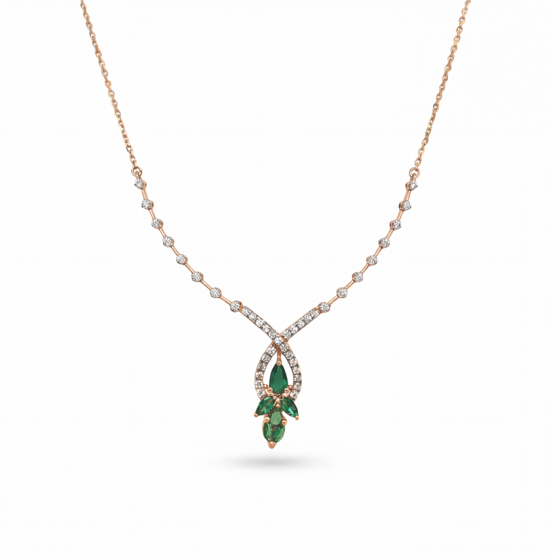 Beautiful 18KT rose gold necklace showcasing a sparkling diamond chain with teardrop pendant and green gemstone cluster on a white background.