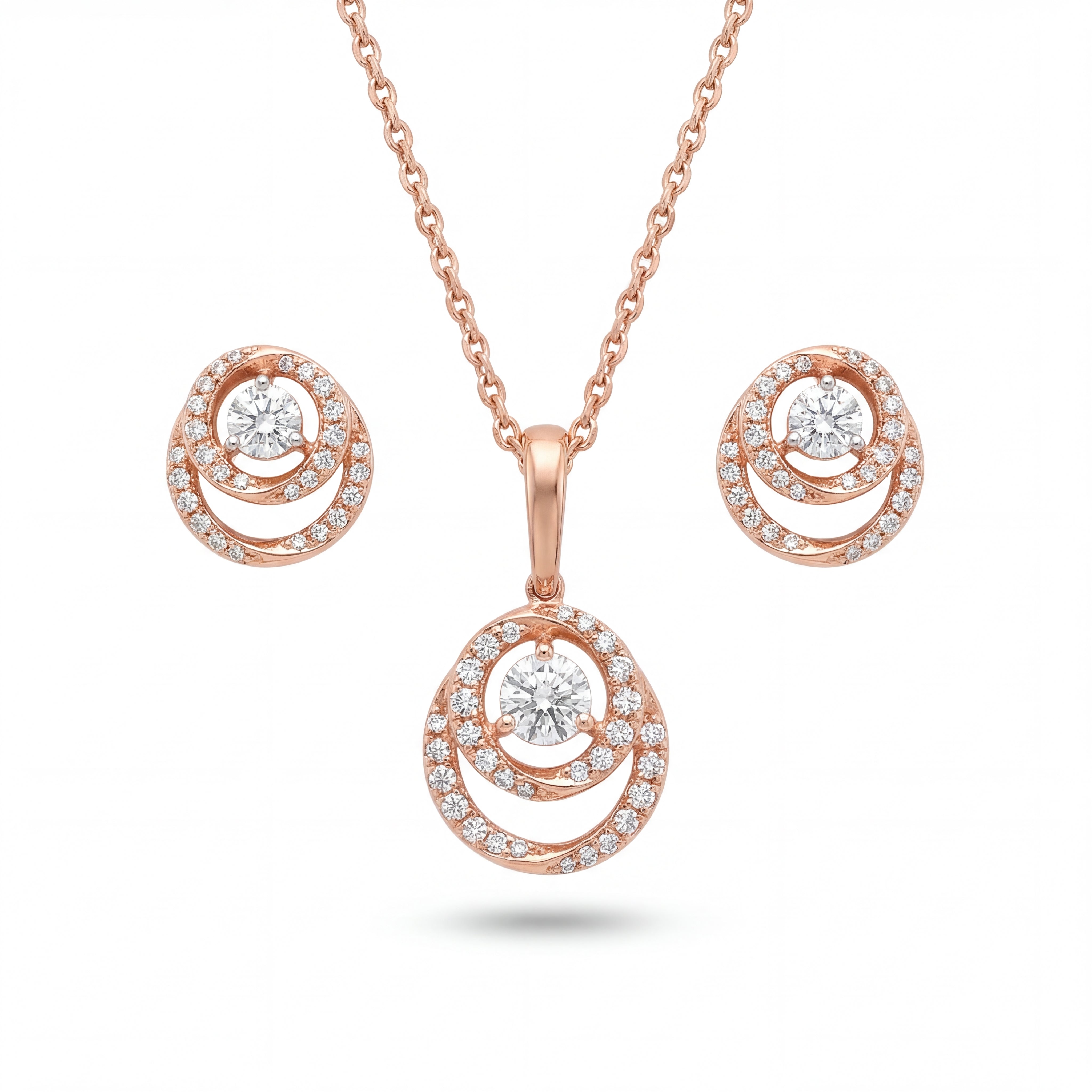 Beautiful 18KT rose gold jewelry set showcasing round layered pendants with sparkling center diamonds and coordinated earrings on a white background.