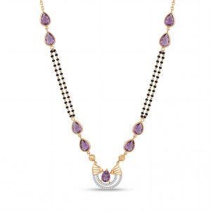Elegant 18K gold mangalsutra necklace featuring pear-shaped purple gemstones, dual black bead chains, and a diamond-accented pendant on a white background by Pachchigar Jewellers Ashokbhai.
