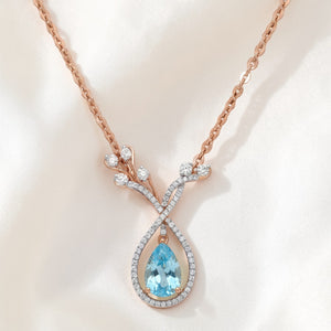 Luxurious 18K rose gold aquamarine diamond designer pendant necklace featuring pear shaped blue gemstone with diamond leaf inspired drop setting by Pachchigar Jewellers Ashokbhai