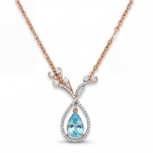 Elegant 18K rose gold blue topaz diamond pendant necklace featuring pear cut blue topaz with pavé diamond halo and floral branch motif by Pachchigar Jewellers Ashokbhai