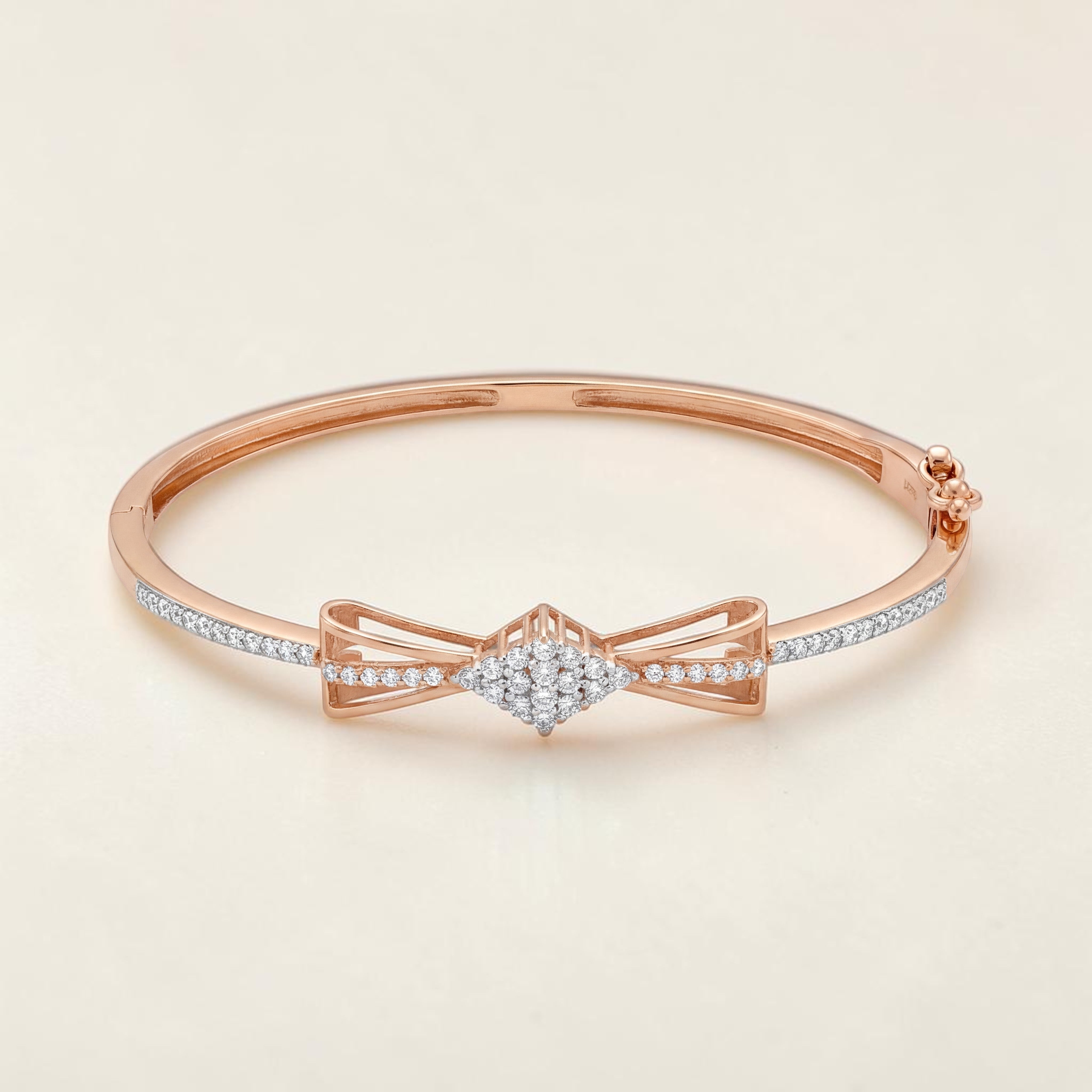 Elegant 18K rose gold diamond kada featuring a graceful bow motif, brilliant round diamond cluster centerpiece, and pavé-set diamond accents. Luxury designer bracelet by Pachchigar Jewellers.