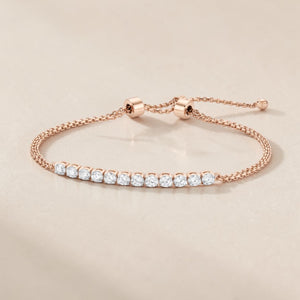 Luxurious 18K rose gold diamond minimal bracelet featuring graduated round diamond line setting with adjustable pull chain by Pachchigar Jewellers Ashokbhai