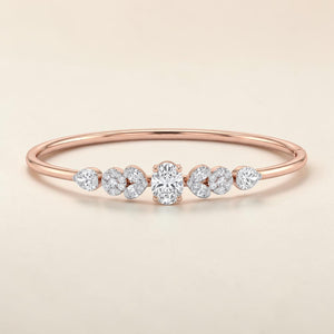 Delicate 18K rose gold diamond bangle featuring an oval center diamond, floral-inspired diamond clusters, and a sleek minimalist design. Elegant luxury bracelet by Pachchigar Jewellers.