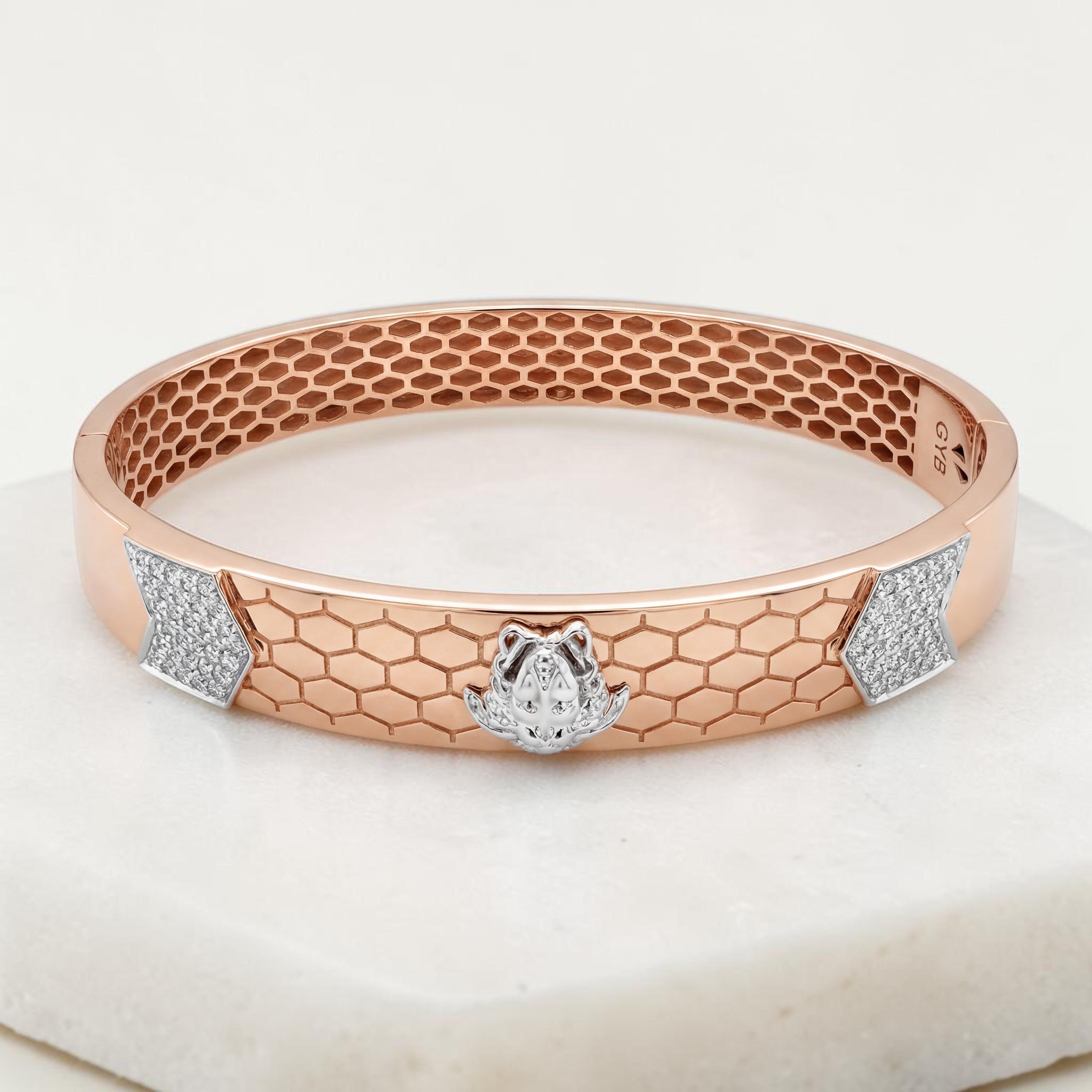 Elegant 18K rose gold diamond kada featuring a honeycomb pattern, white gold Lord Ganesh motif, and sparkling diamond accents. A luxurious designer bracelet by Pachchigar Jewellers.