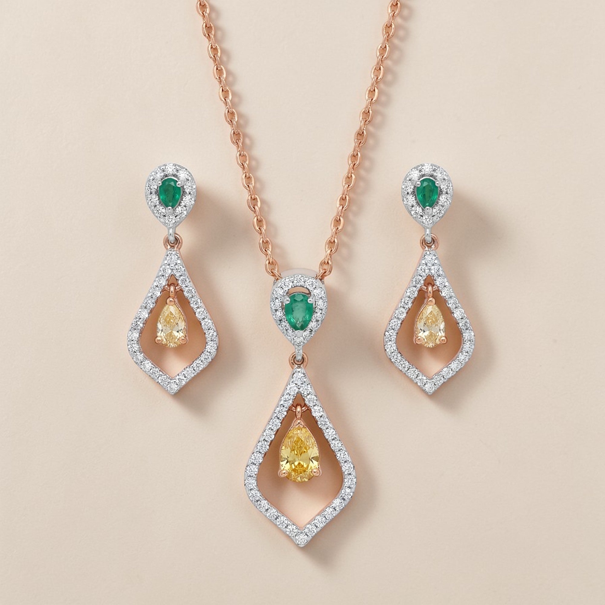 Luxurious 18K rose gold multicolor diamond jewelry set featuring emerald accents, yellow pear diamonds, pendant necklace and matching drop earrings by Pachchigar Jewellers Ashokbhai