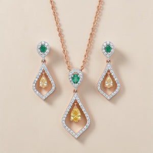 Luxurious 18K rose gold multicolor diamond jewelry set featuring emerald accents, yellow pear diamonds, pendant necklace and matching drop earrings by Pachchigar Jewellers Ashokbhai