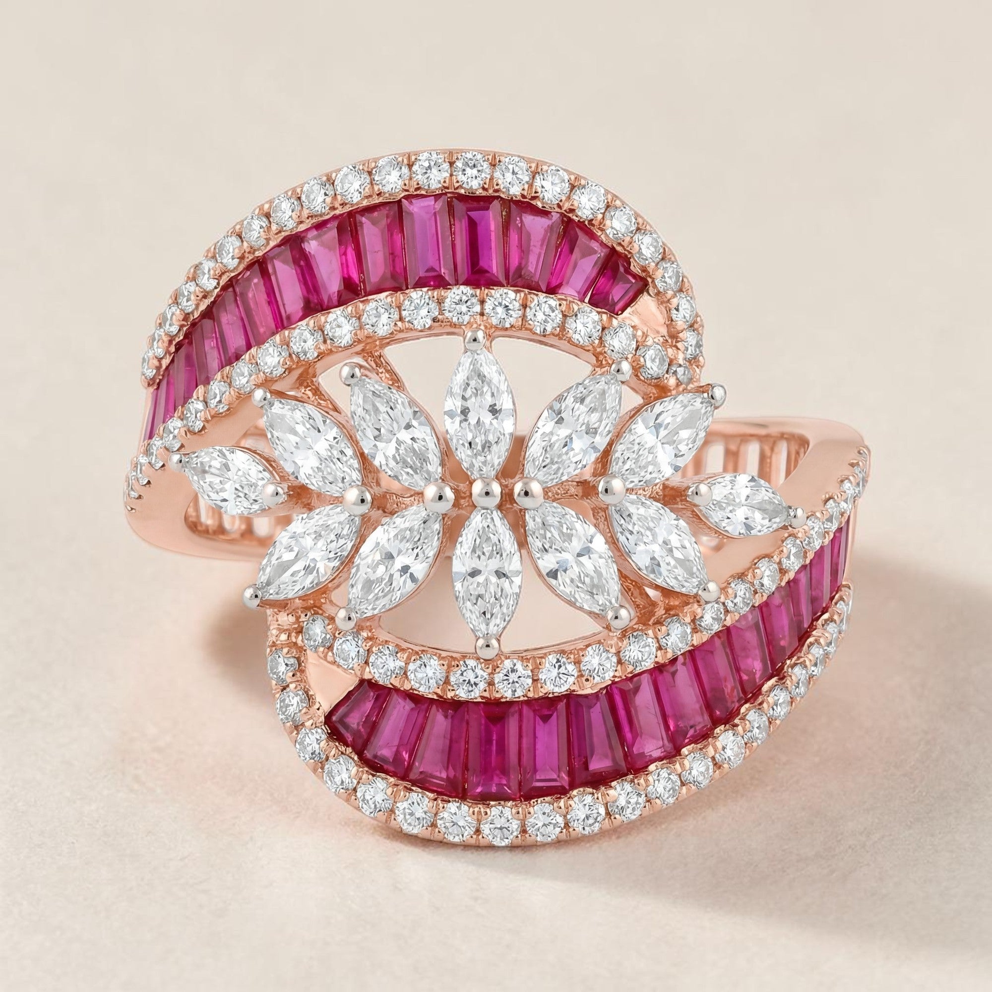 Luxurious 18K rose gold statement ring featuring vibrant ruby baguette stones, pavé diamonds, and marquise-cut diamond floral motifs in an elegant openwork design.