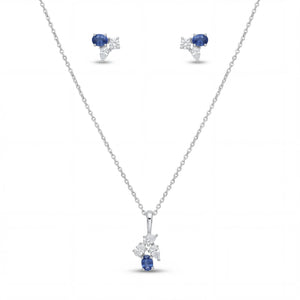 Elegant 18K white gold blue sapphire diamond pendant earrings set featuring oval blue sapphires with floral diamond accents necklace and matching stud earrings by Pachchigar Jewellers Ashokbhai