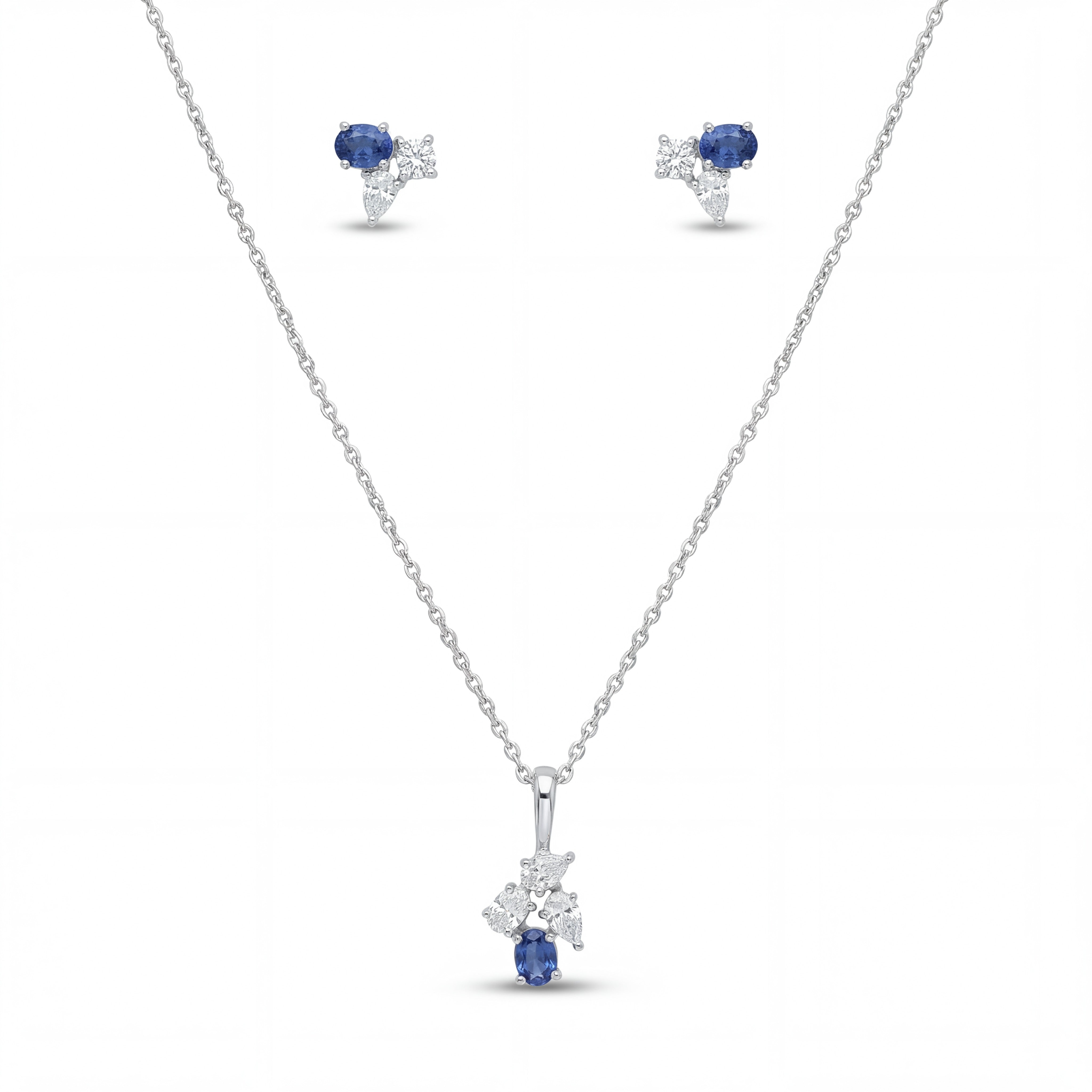 Elegant 18K white gold blue sapphire diamond pendant earrings set featuring oval blue sapphires with floral diamond accents necklace and matching stud earrings by Pachchigar Jewellers Ashokbhai
