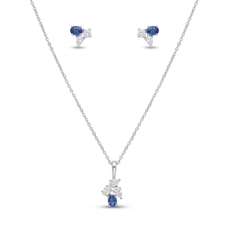 Elegant 18K white gold blue sapphire diamond pendant earrings set featuring oval blue sapphires with floral diamond accents necklace and matching stud earrings by Pachchigar Jewellers Ashokbhai