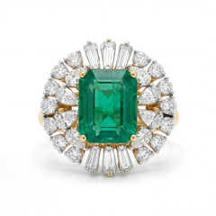 Elegant 18K yellow gold emerald diamond halo statement ring featuring emerald cut center emerald with pear and baguette cut diamond surround by Pachchigar Jewellers Ashokbhai