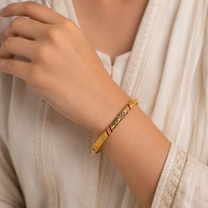 Elegant 18K yellow gold heritage bangle featuring intricate black filigree detailing, rich maroon Meenakari enamel accents, textured gold craftsmanship, and a timeless traditional design. Luxury gold bracelet by Pachchigar Jewellers.