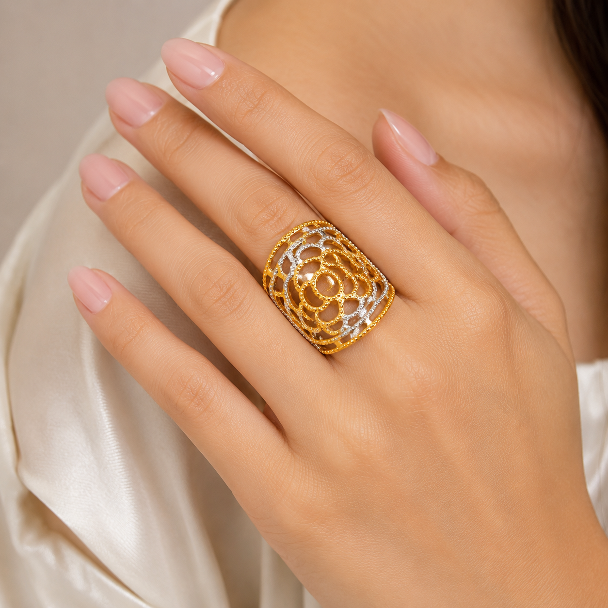 Elegant 18K yellow gold statement ring featuring an intricate floral filigree openwork design, dual-tone white gold accents, delicate beaded detailing, and a bold contemporary silhouette. Luxury designer gold ring by Pachchigar Jewellers.
