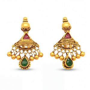 Elegant 22KT yellow gold jhumka earrings featuring ruby triangle accents, emerald teardrop danglers, and hanging gold bead charms on a white background.