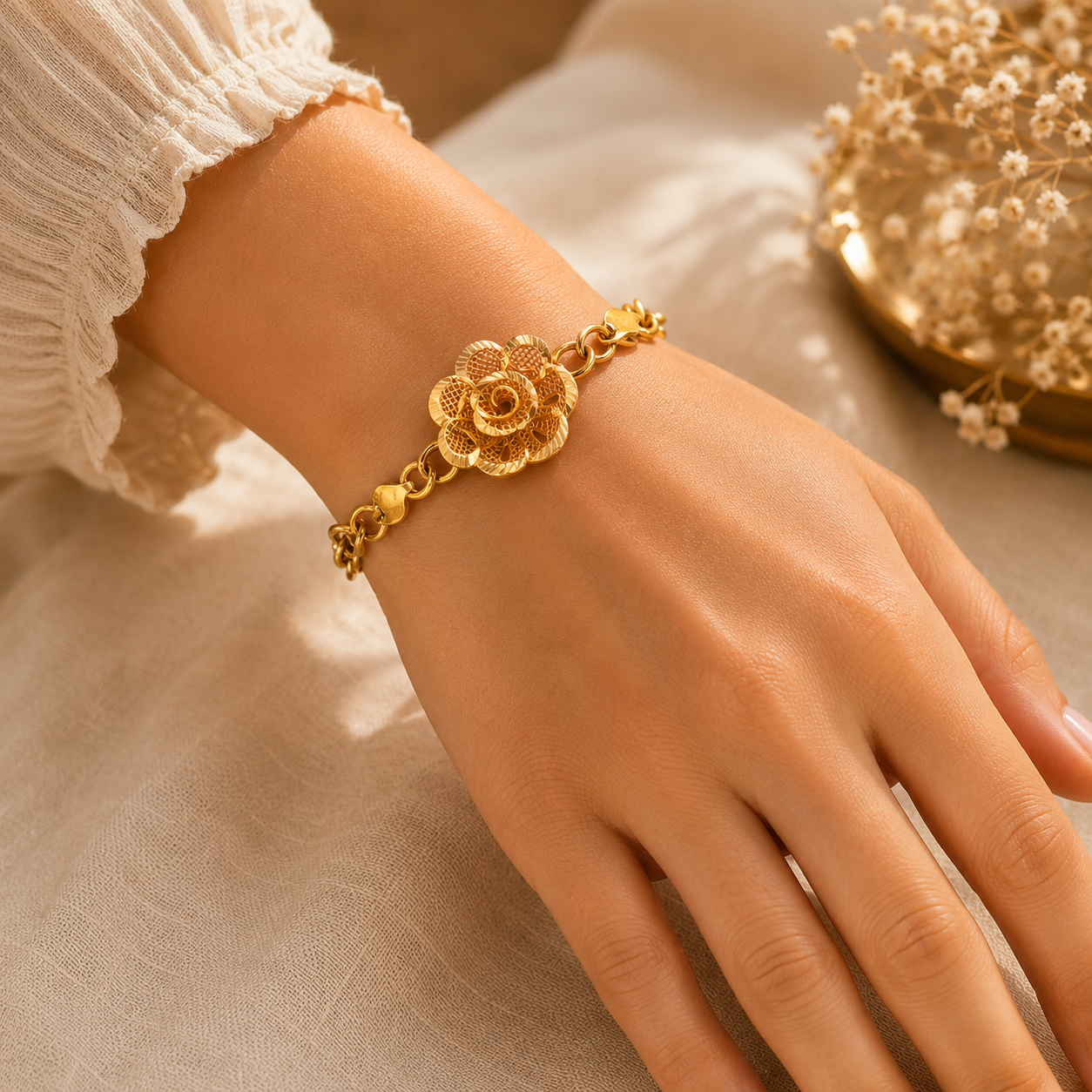 Elegant 22KT yellow gold bracelet featuring a beautifully crafted floral filigree centerpiece with textured petals and a stylish link chain, gracefully worn on a woman's wrist, perfect for festive occasions, traditional wear, and gifting.
