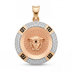 Luxury 22KT gold round pendant featuring a Medusa-inspired face motif, radiant engraved center, diamond-studded outer ring, and black Greek key accents on a white background.