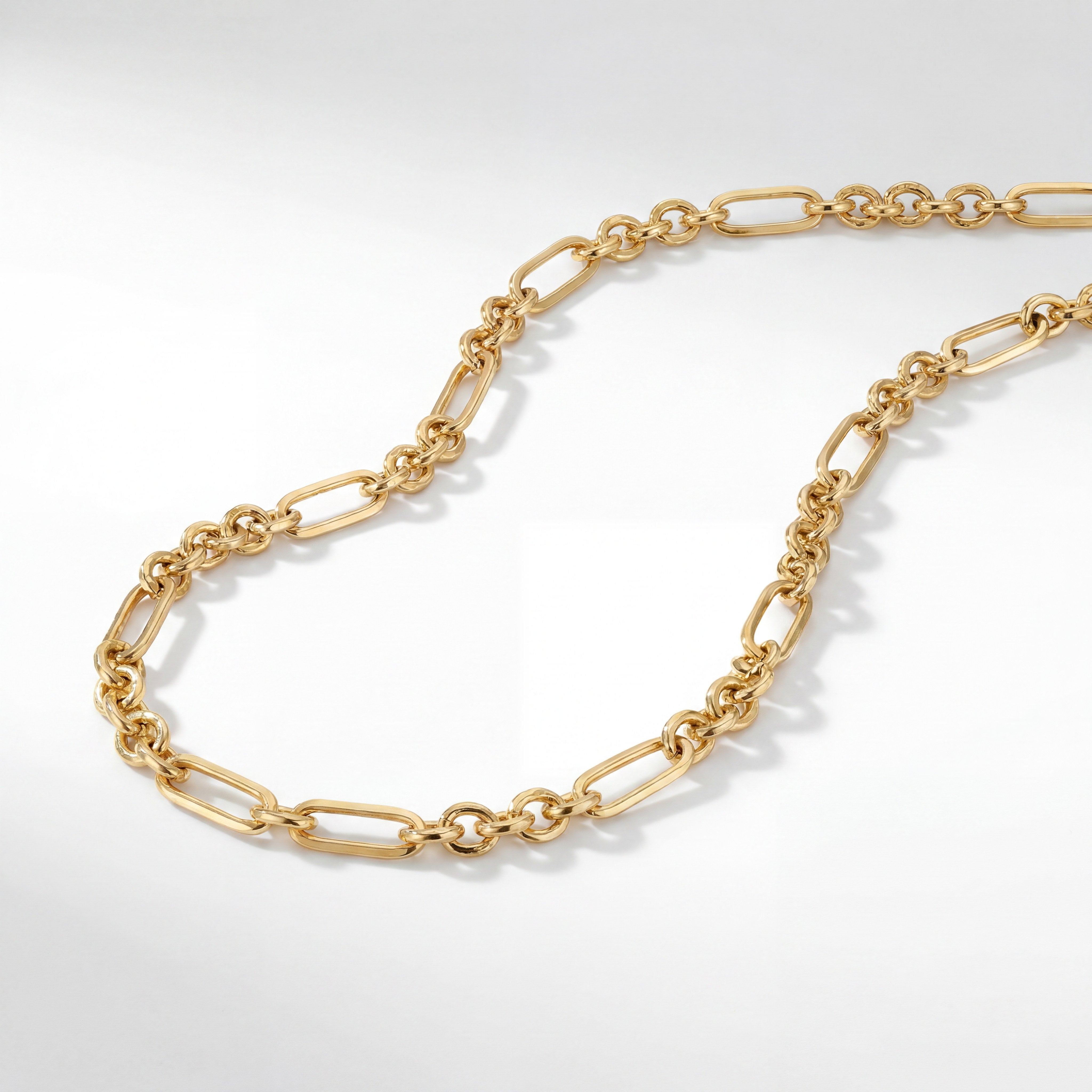 22KT BIS Hallmarked gold paperclip link chain featuring elongated oval links connected with polished round links in a contemporary design. A lightweight, elegant yellow gold chain for men and women, perfect for everyday wear, layering, and gifting from Pachchigar Jewellers.