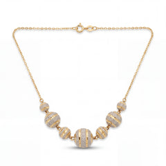 Elegant 22KT yellow gold necklace featuring graduated round beads with sparkling textured stripe detailing on a delicate chain against a white background.
