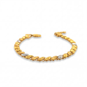 Elegant 22KT gold bracelet featuring alternating leaf-shaped links with white gold accents on a white background.