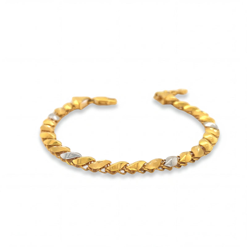 Elegant 22KT gold bracelet featuring alternating leaf-shaped links with white gold accents on a white background.