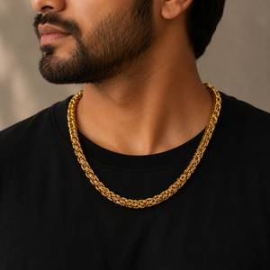 Man wearing a 22K gold Byzantine link chain featuring intricately woven interlocking links with a polished finish, styled with a black t-shirt for a bold, luxurious, and timeless look.