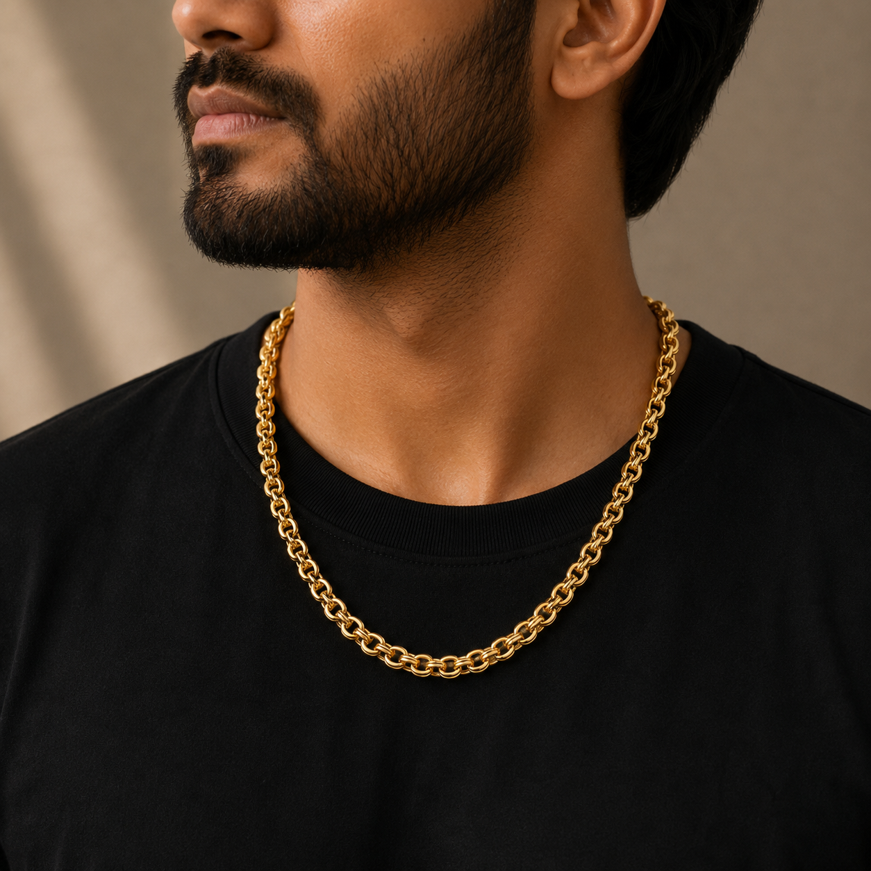Man wearing a 22K gold double link chain featuring interlocking rounded links with a polished finish, paired with a black t-shirt for a bold and timeless everyday style.
