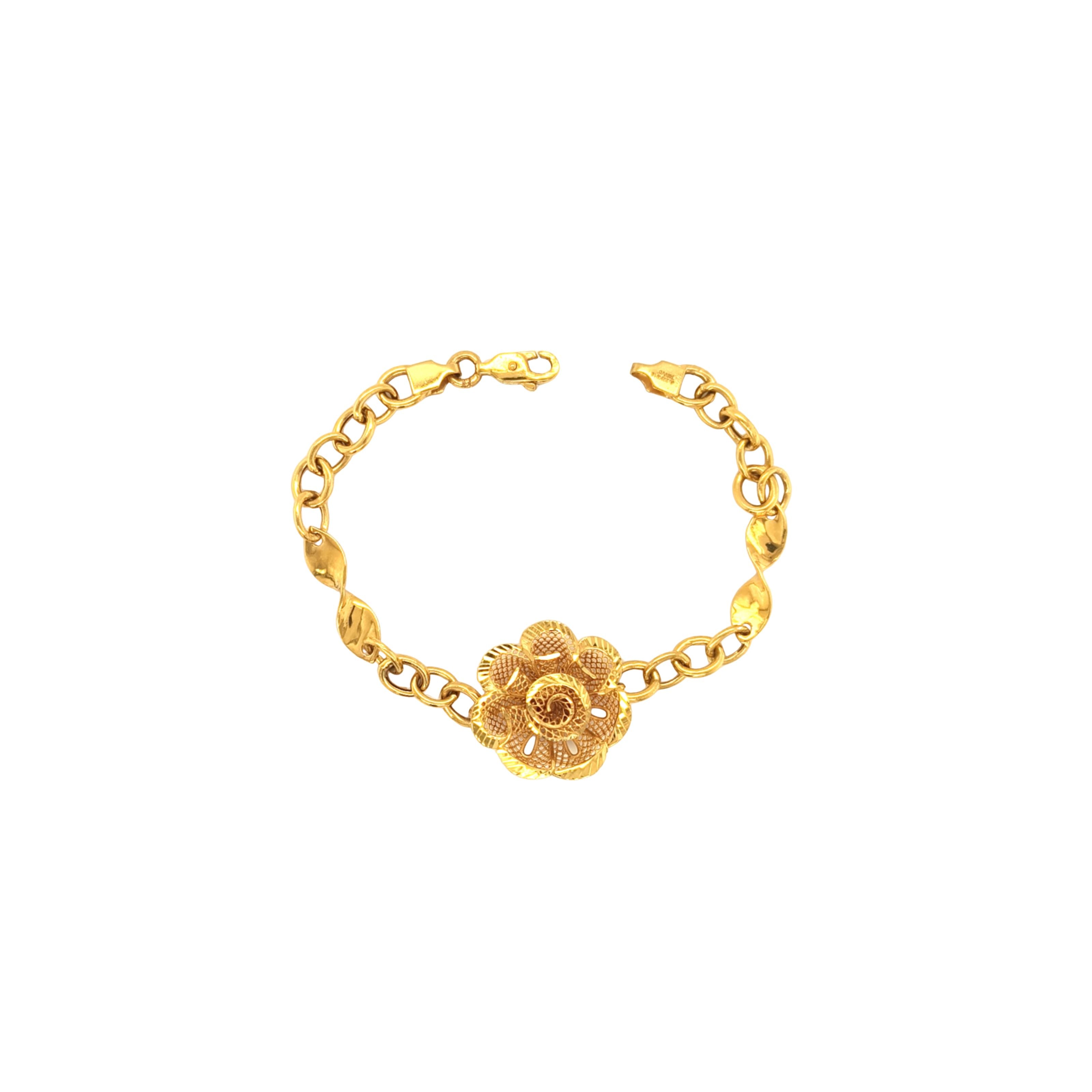 Elegant 22K yellow gold bracelet featuring a detailed floral filigree centerpiece with textured chain links and a secure clasp on a white background.