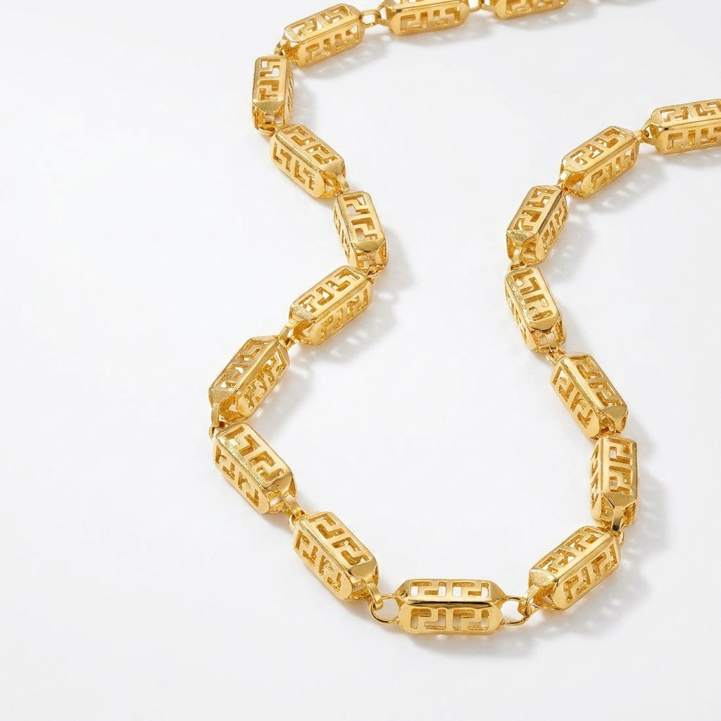 Stylish 22K yellow gold designer chain featuring geometric Greek-inspired patterned links with an intricate openwork finish on a white background.