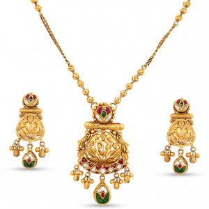 Exquisite 22K yellow gold pendant set featuring intricate heritage temple motifs with red green meenakari detailing, hanging charms, and matching traditional earrings.