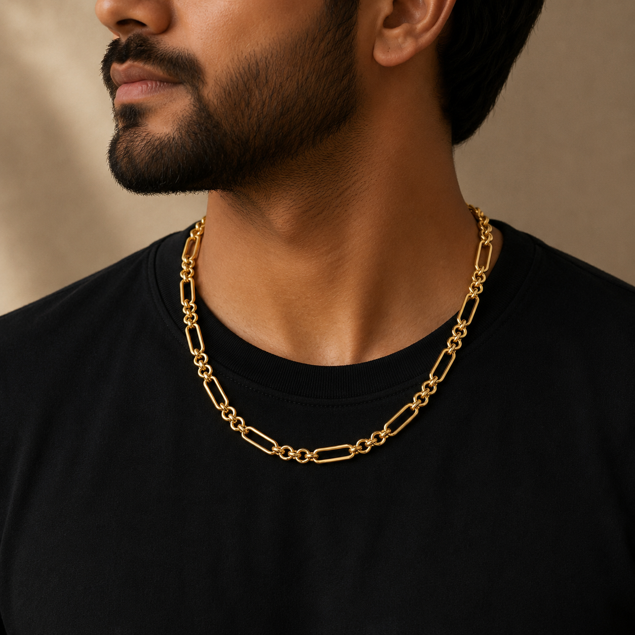 Man wearing a 22K gold modern oval link chain with polished elongated links and round connectors, styled with a black t-shirt for a contemporary everyday look.