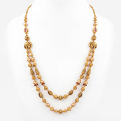 22K gold layered heritage necklace featuring lustrous pearls, ruby-colored stone accents, intricately textured gold beads, elephant motifs, and dual cascading strands, crafted for a regal and timeless traditional look.
