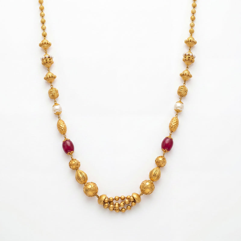 22K gold ruby pearl beaded necklace featuring deep ruby-colored beads, lustrous white pearls, intricately textured gold beads, and a traditional gold beaded centerpiece, crafted for an elegant and timeless ethnic look.