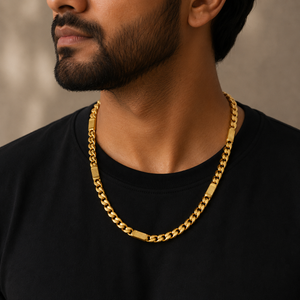 Man wearing a 22K gold textured Cuban link chain featuring bold polished curb links with engraved rectangular accents, styled with a black t-shirt for a modern and sophisticated look.