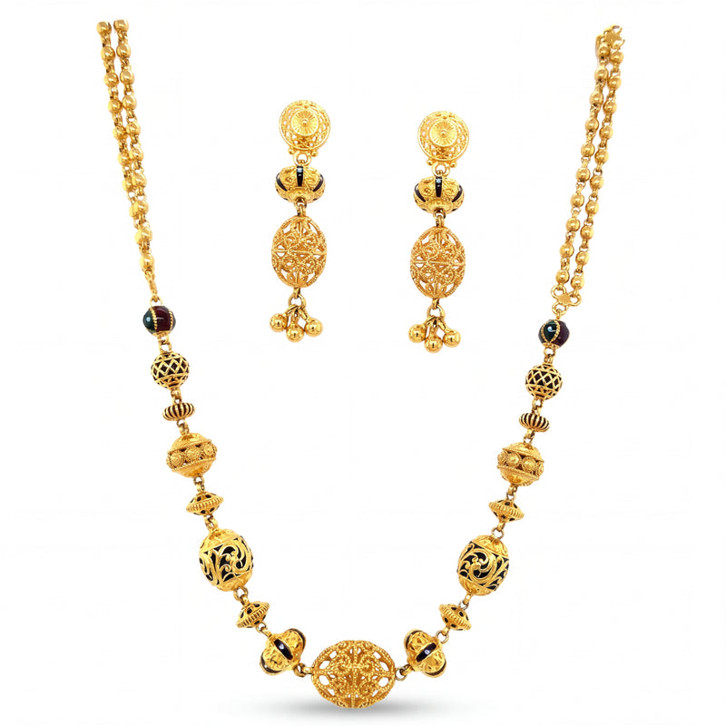 Traditional 22K yellow gold long necklace set featuring ornate filigree beads, antique detailing, black enamel accents, and matching dangling earrings.
