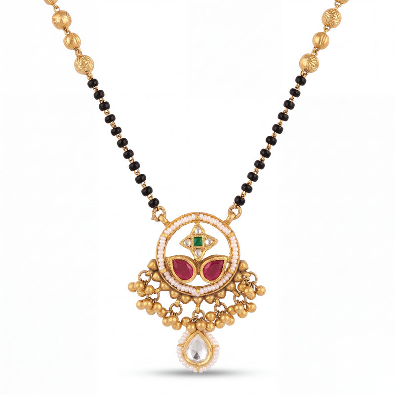 Traditional mangalsutra featuring black bead strands, handcrafted gold chain, designer pendant with ruby, emerald, pearl detailing, dangling gold charms, and festive ethnic styling for bridal and special occasions.