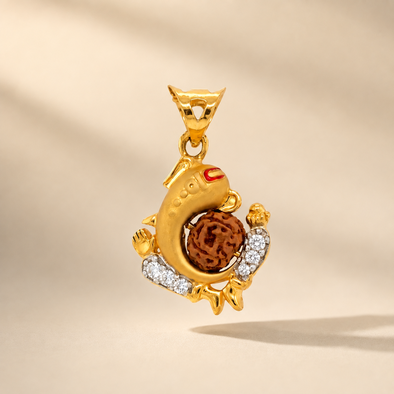 Intricately crafted gold pendant featuring a Lord Ganesha-inspired design, a textured Rudraksha bead centerpiece, red enamel detailing, and sparkling diamond accents.
