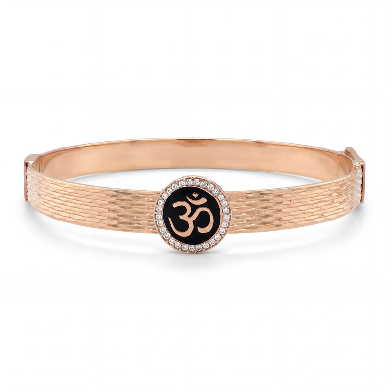 Rose gold textured kada featuring a central Om symbol set on black enamel, encircled by a halo of diamonds, combining spirituality with elegant contemporary design.