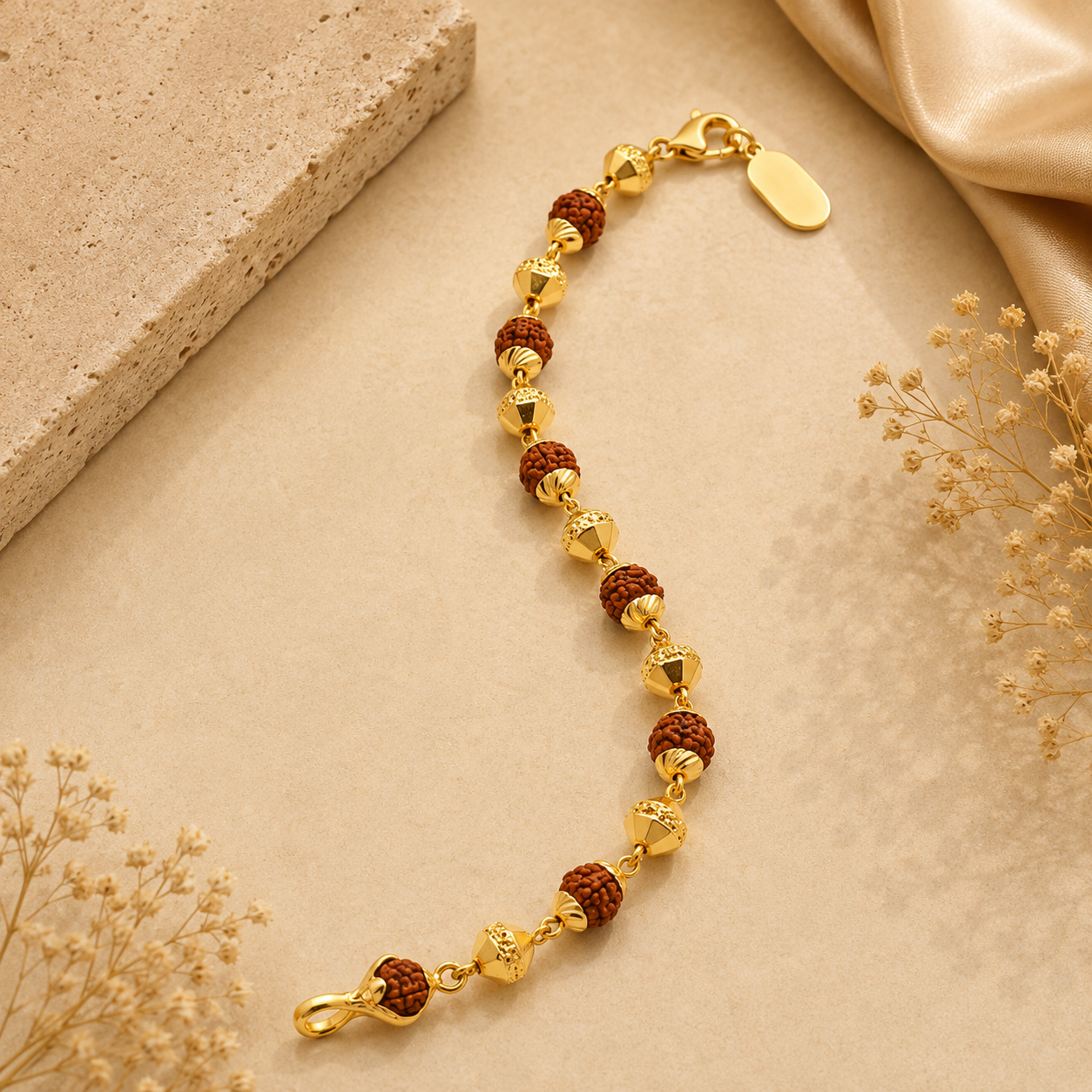 Gold bracelet featuring multiple Rudraksha beads, detailed gold beads and geometric accents, finished with a secure clasp and adjustable chain.